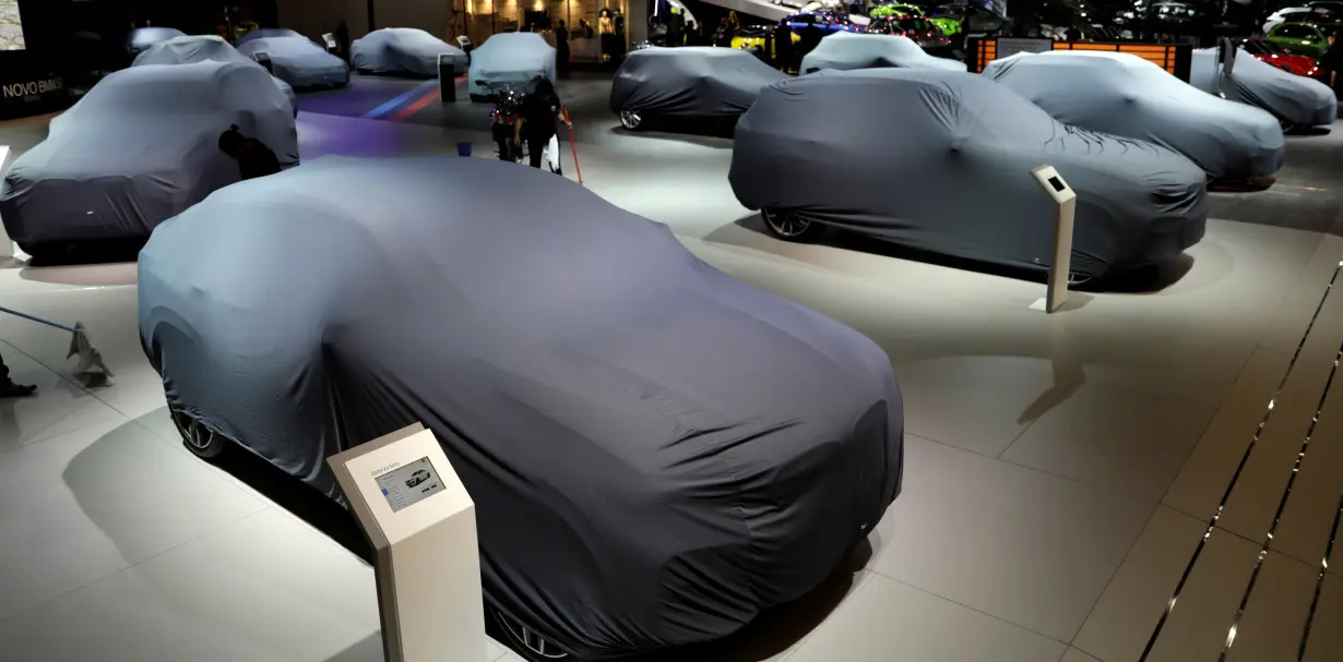 Covered new cars are displayed during the Salao do Automovel International Auto Show in Sao Paulo