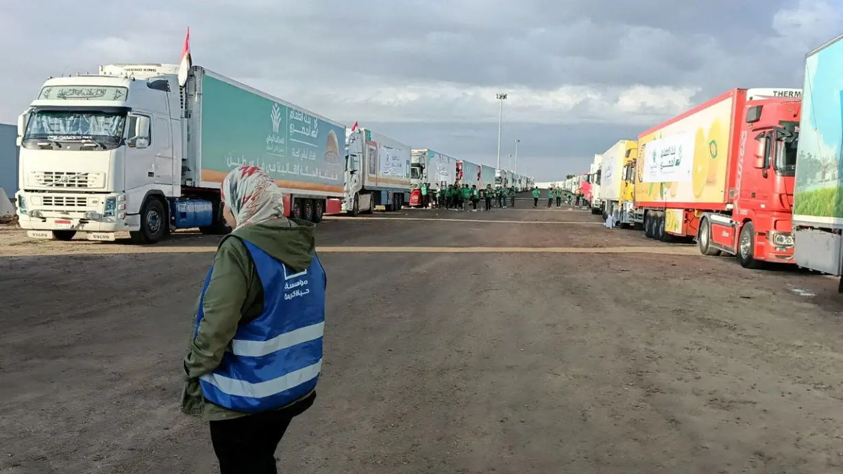 FILE PHOTO: Trucks carrying humanitarian aid from Egyptian NGOs for Palestinians, wait for the reopening of the Rafah crossing at the Egyptian side