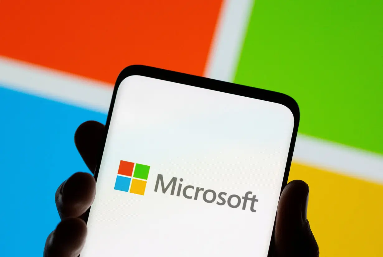 FILE PHOTO: Smartphone is seen in front of Microsoft logo displayed in this illustration