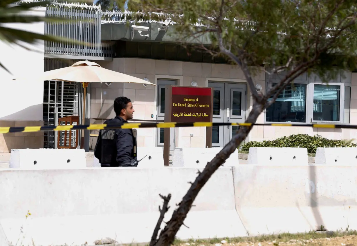 FILE PHOTO: A police officer walks outside the U.S. embassy after a suicide attack in Tunis