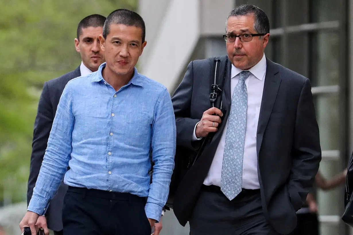FILE PHOTO: Ex-Goldman Sachs banker Roger Ng and his lawyer Marc Agnifilo leave the federal court in New York