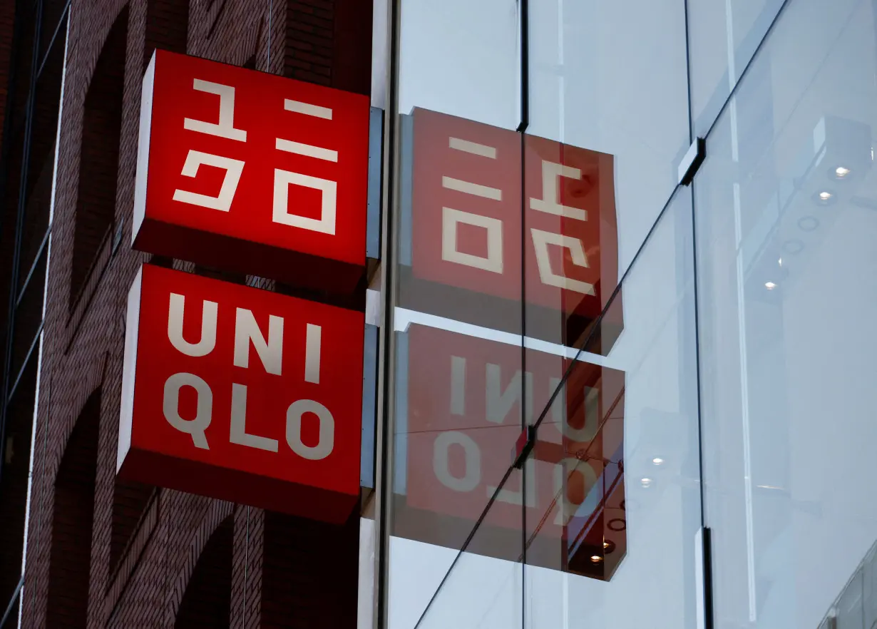 FILE PHOTO: Fast Retailing's Uniqlo sign boards are displayed at a casual clothing store in Tokyo