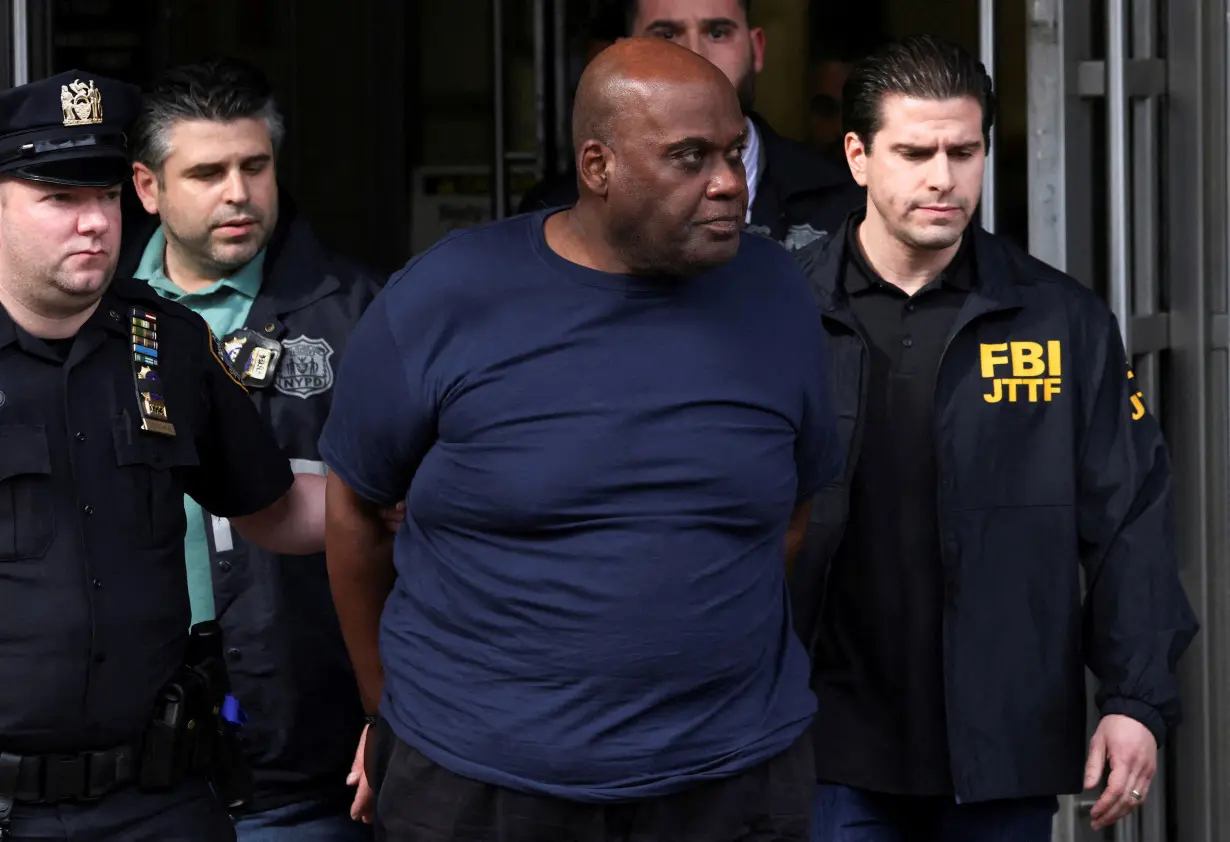 Frank James, the suspect in the Brooklyn subway shooting walks outside a police precinct in New York City