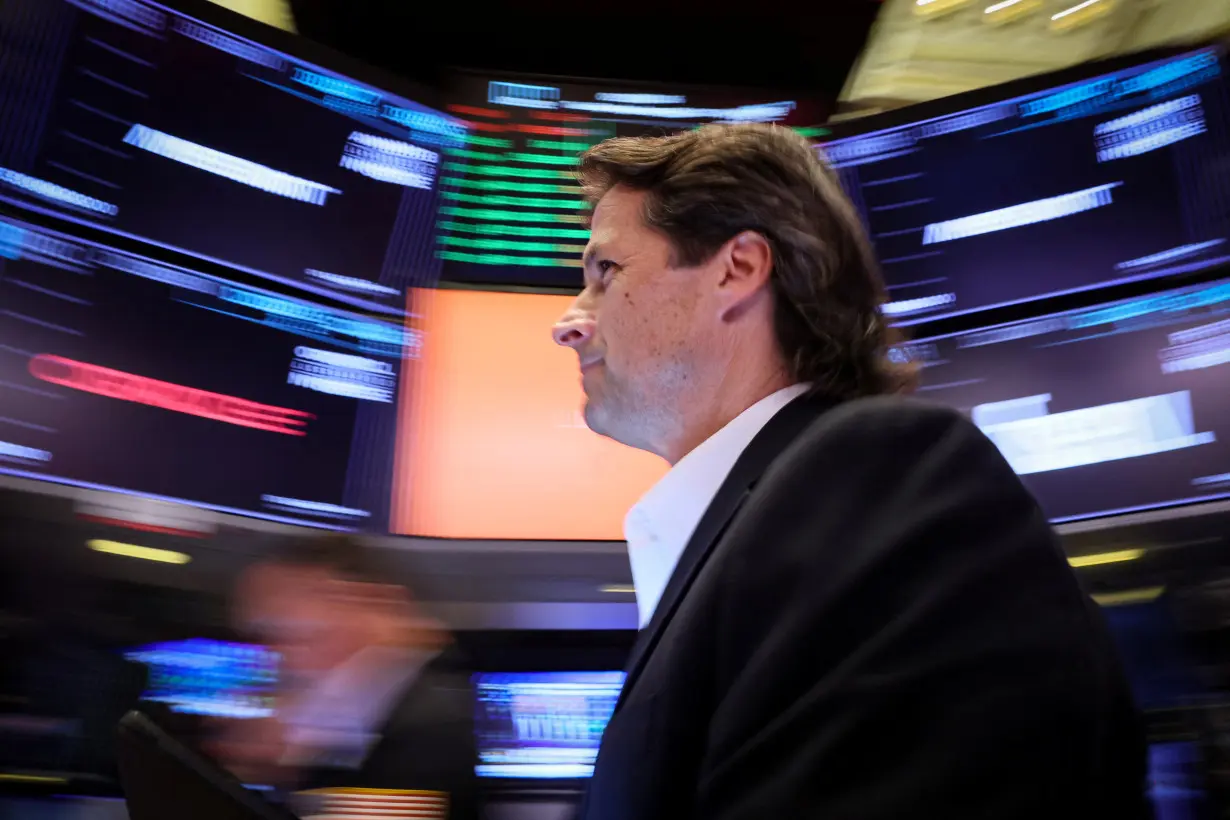 Traders work on the floor of the NYSE in New York