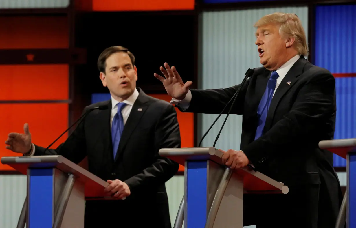 FILE PHOTO: Republican U.S. presidential candidate Rubio and rival candidate Trump speak simultaneously at the U.S. Republican presidential candidates debate in Detroit