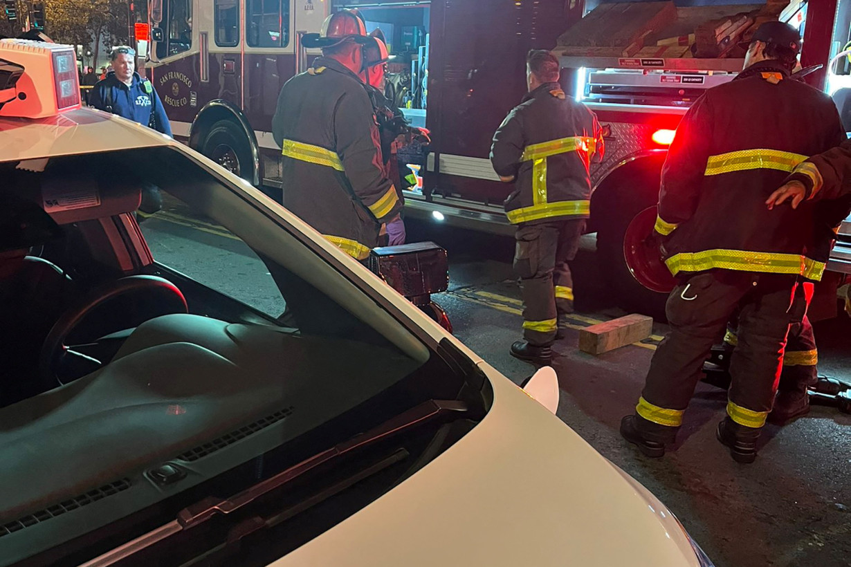 San Francisco firefighters attend the scene where pedestrian was struck by a Cruise robotaxi