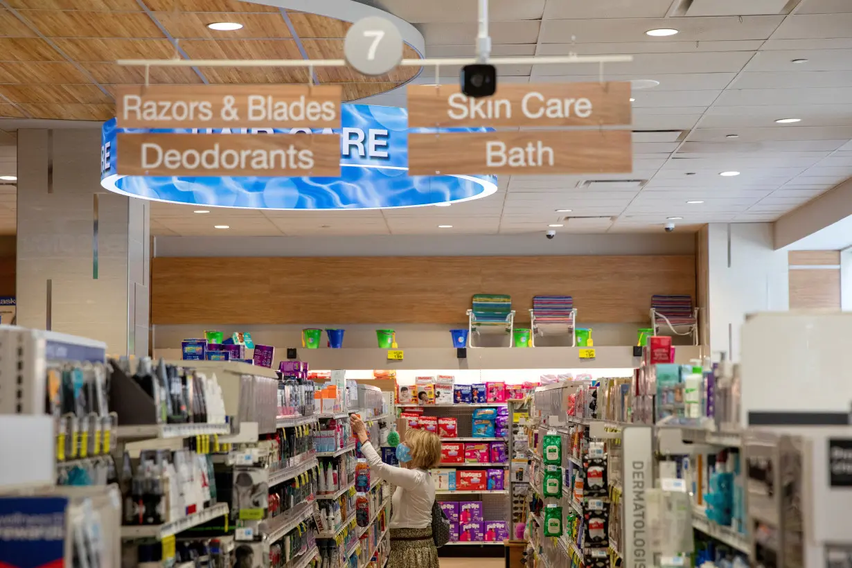 FILE PHOTO: A woman shops inside a Rite Aid store underneath a DeepCam security camera in New York City, New York