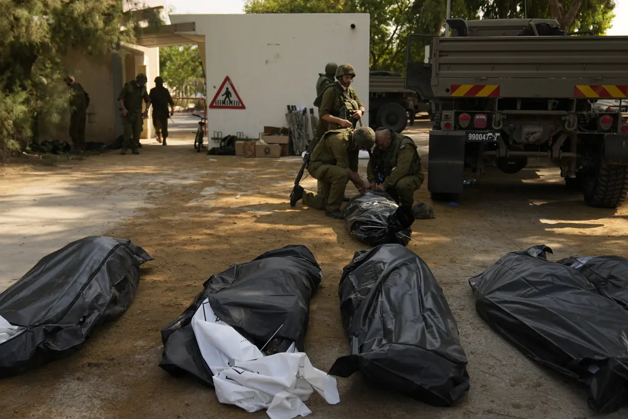 Israeli village near the Gaza border lies in ruin, filled with the bodies of residents and militants