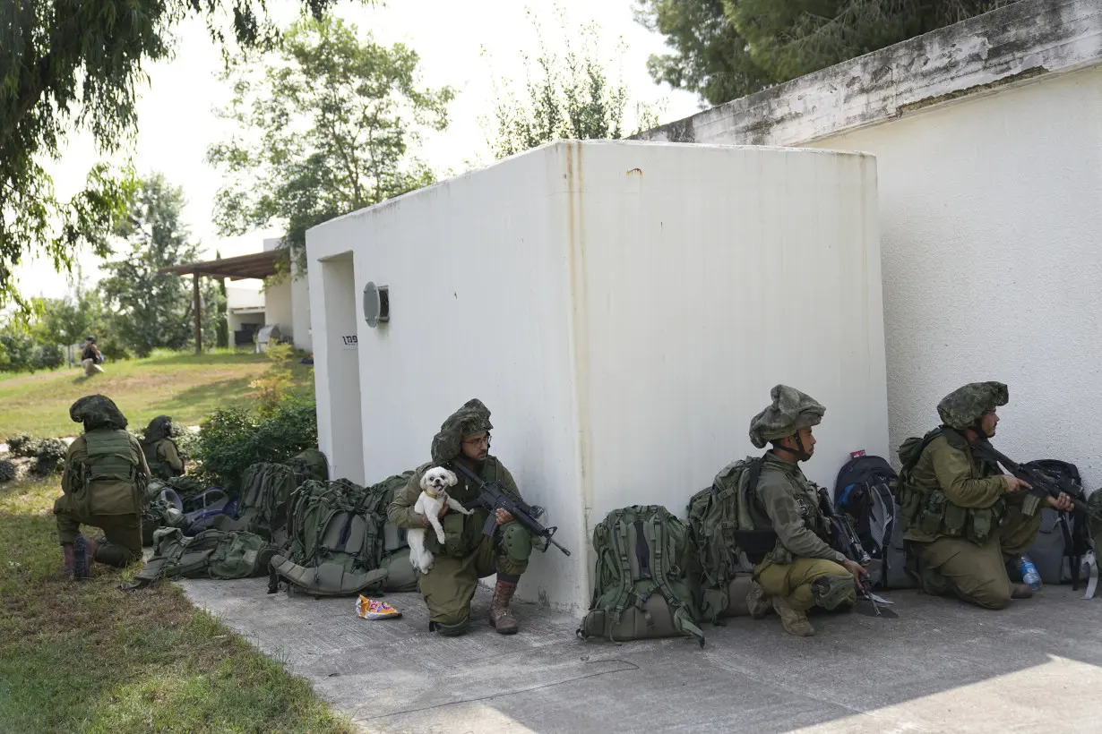 Israeli village near the Gaza border lies in ruin, filled with the bodies of residents and militants