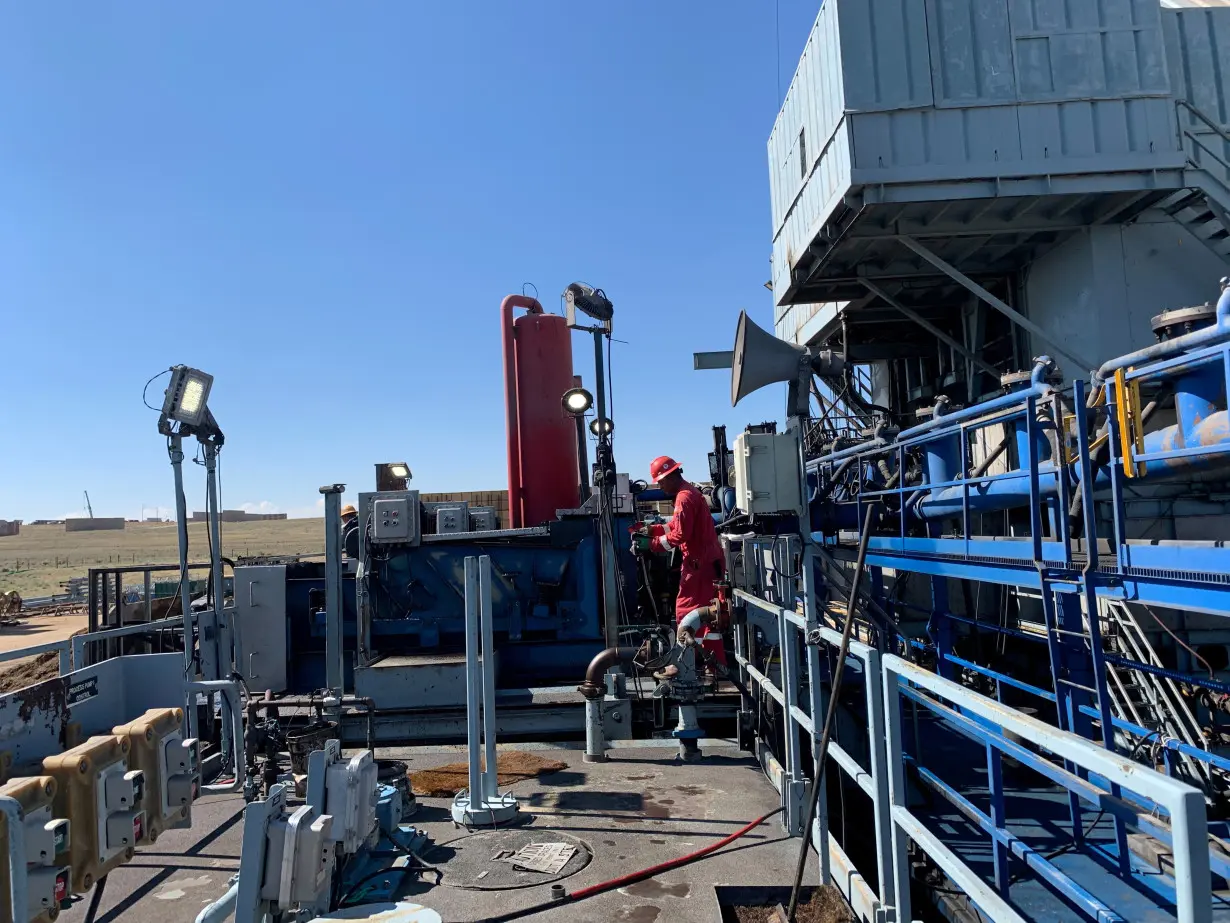 Men work on an electric drilling operating at a Chevron site in Kersey