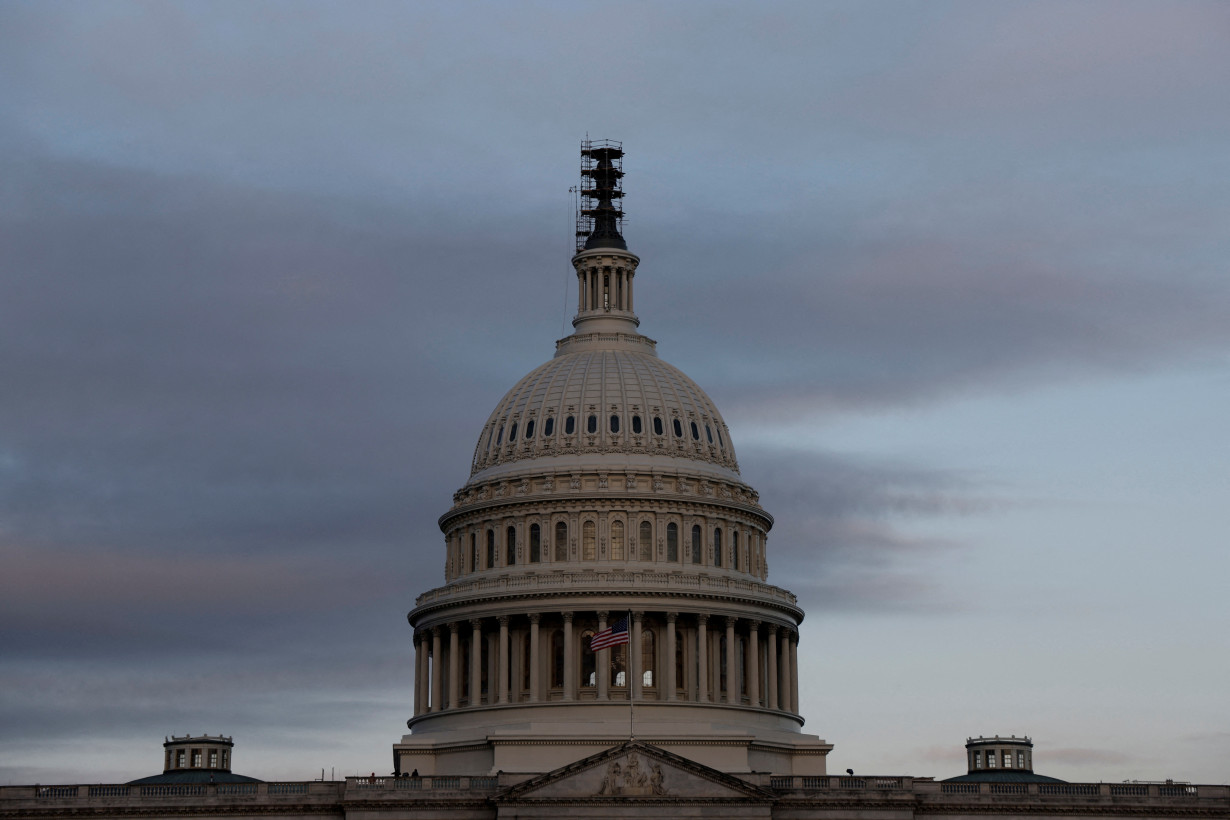 FILE PHOTO: The morning sky brightens over the U.S. Capitol in Washington