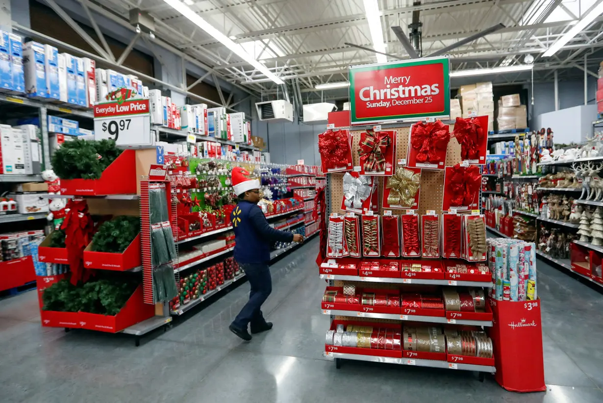 An employee checks on a Christmas display at a Walmart store in Chicago