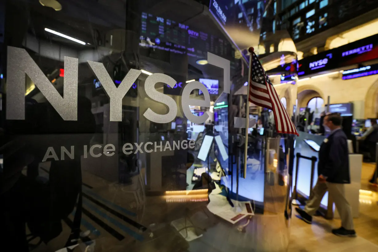 FILE PHOTO: Traders work on the floor of the NYSE in New York