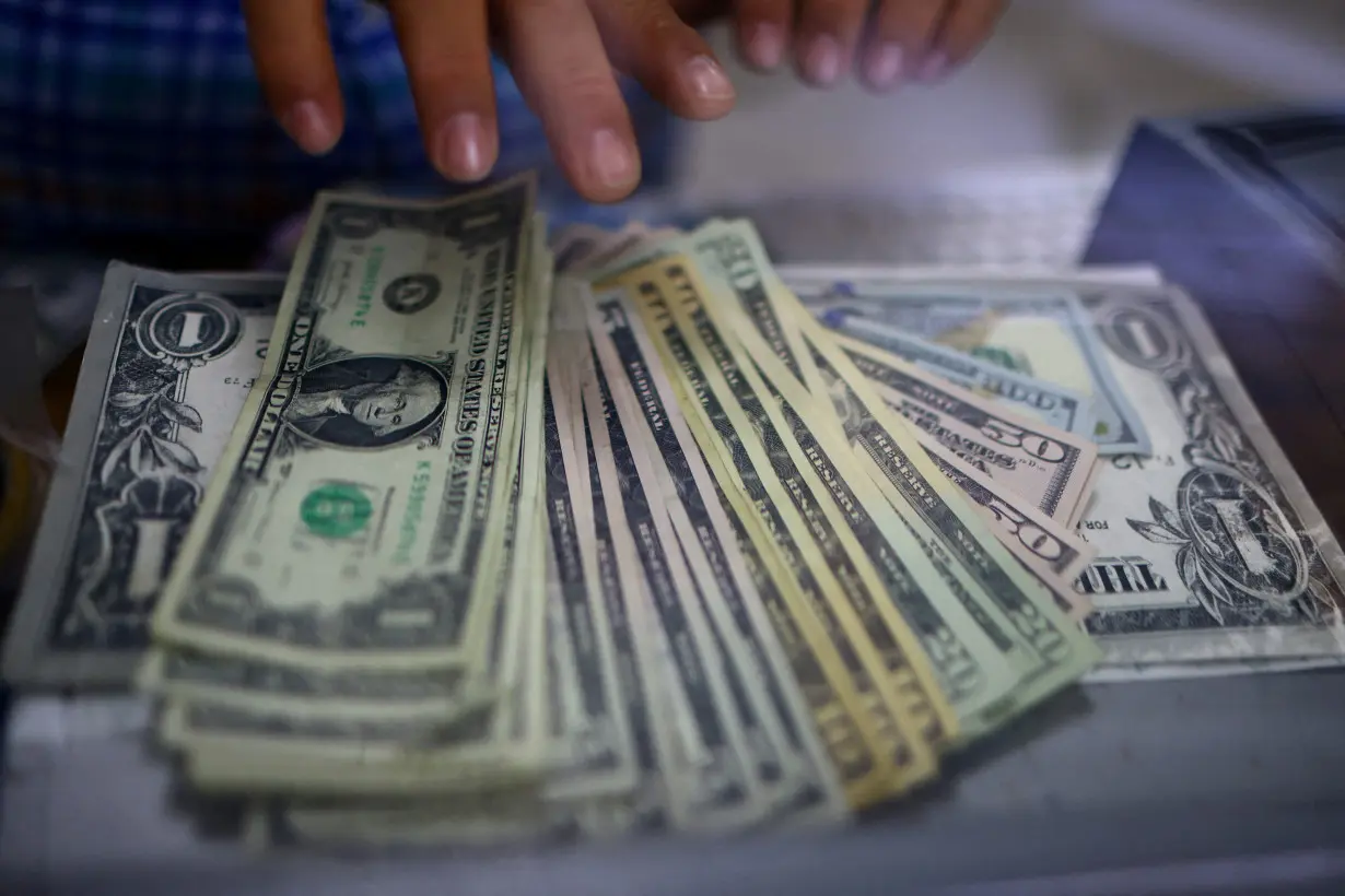 FILE PHOTO: The employee of a currency exchange shop counts U.S. dollar banknotes in Ciudad Juarez