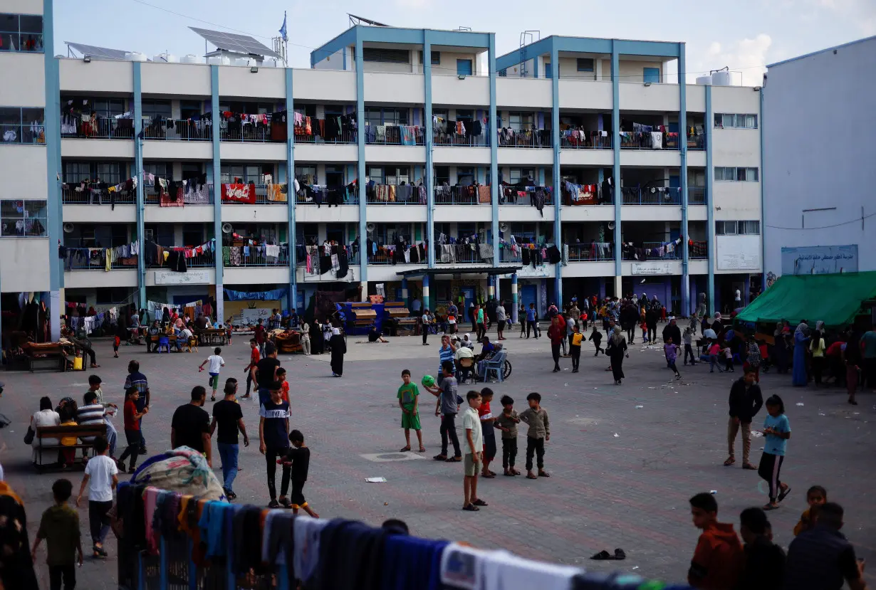 Palestinians, who fled their houses amid Israeli strikes, shelter at a United Nations-run school