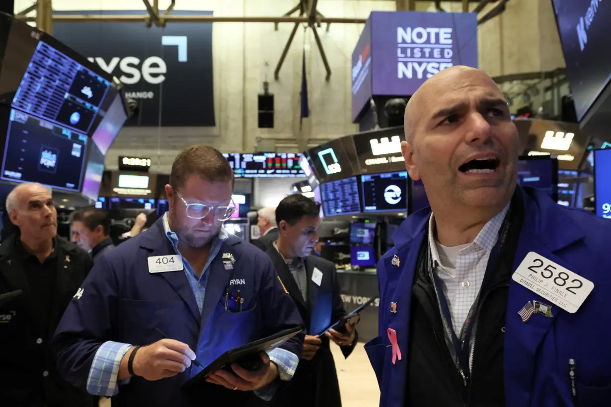 Traders work on the floor of the NYSE in New York