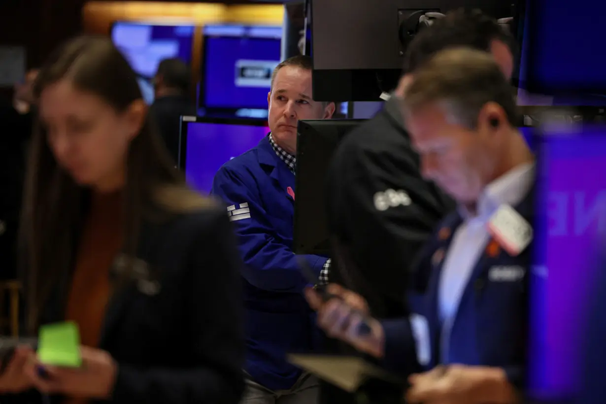 Traders work on the floor of the NYSE in New York