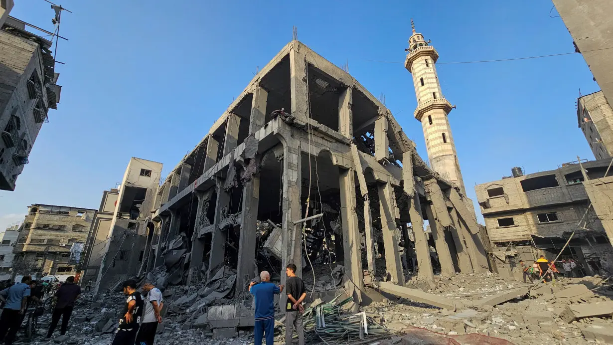 Palestinians inspect the remains of a mosque destroyed in Israeli strikes, in the northern Gaza Strip