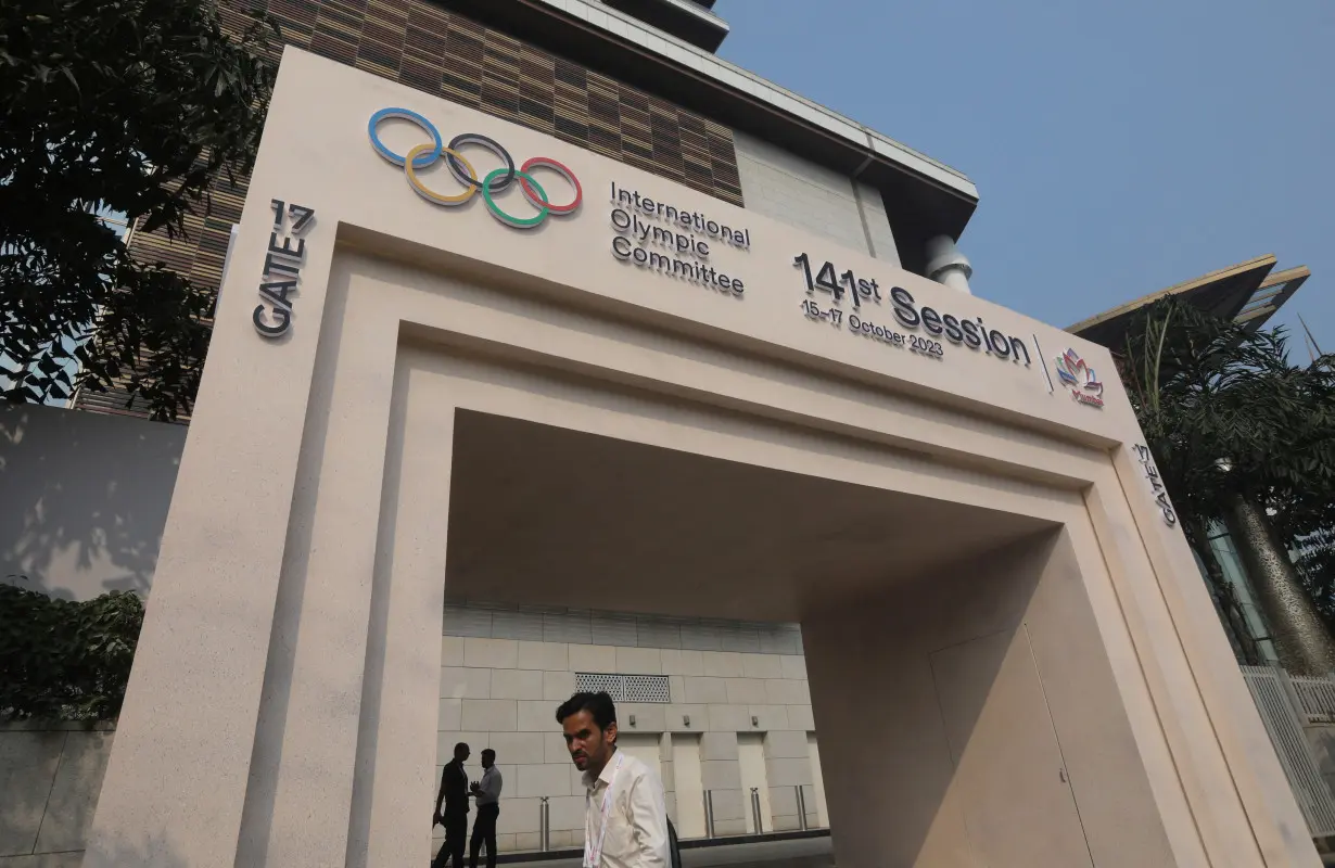 A man walks past the entrance of the 141st IOC Session venue, in Mumbai