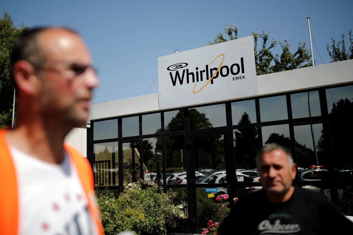 FILE PHOTO: Employees stand at the Whirlpool company plant in the northern city of Amiens