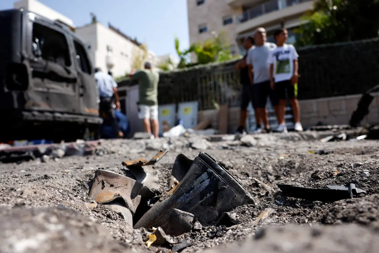 The remains of a rocket fired from the Gaza Strip into Israel lies on a road where it fell in Ashkelon, southern Israel