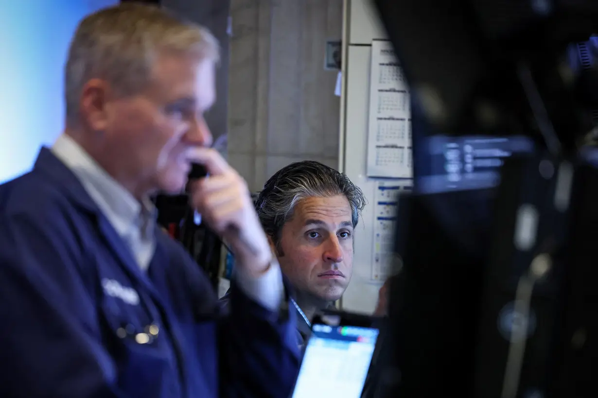 Traders work on the floor of the NYSE in New York