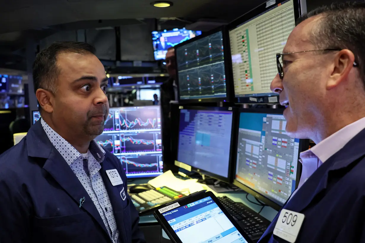 Traders work on the floor of the NYSE in New York