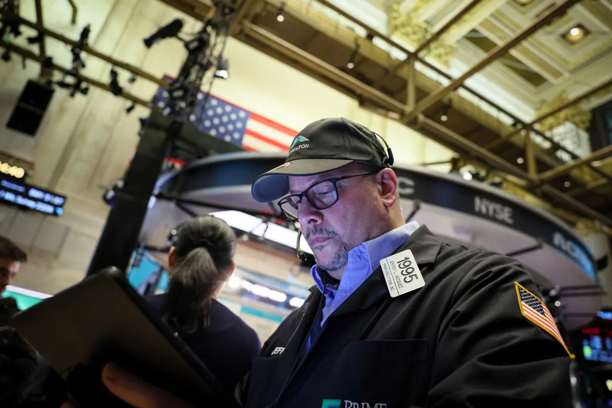 Traders work on the floor of the NYSE in New York