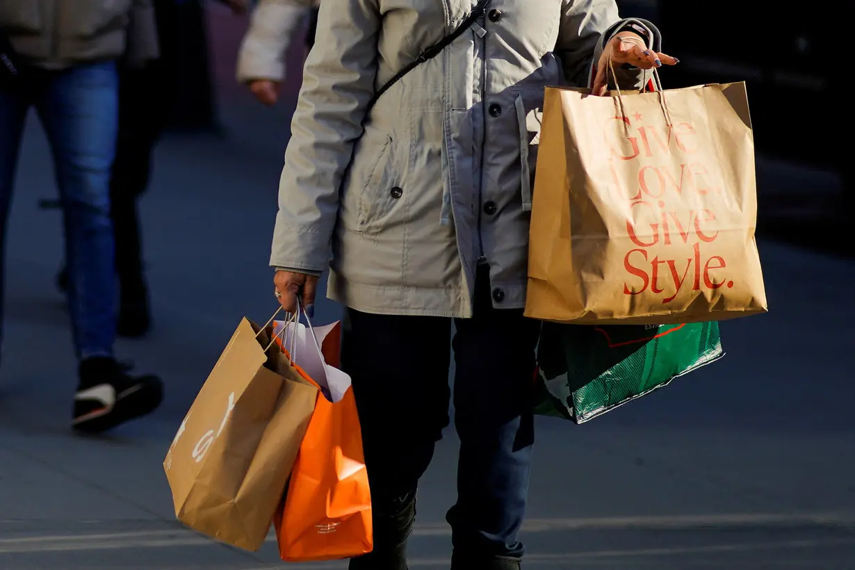 FILE PHOTO: A woman carries shopping bags during the holiday season in New York