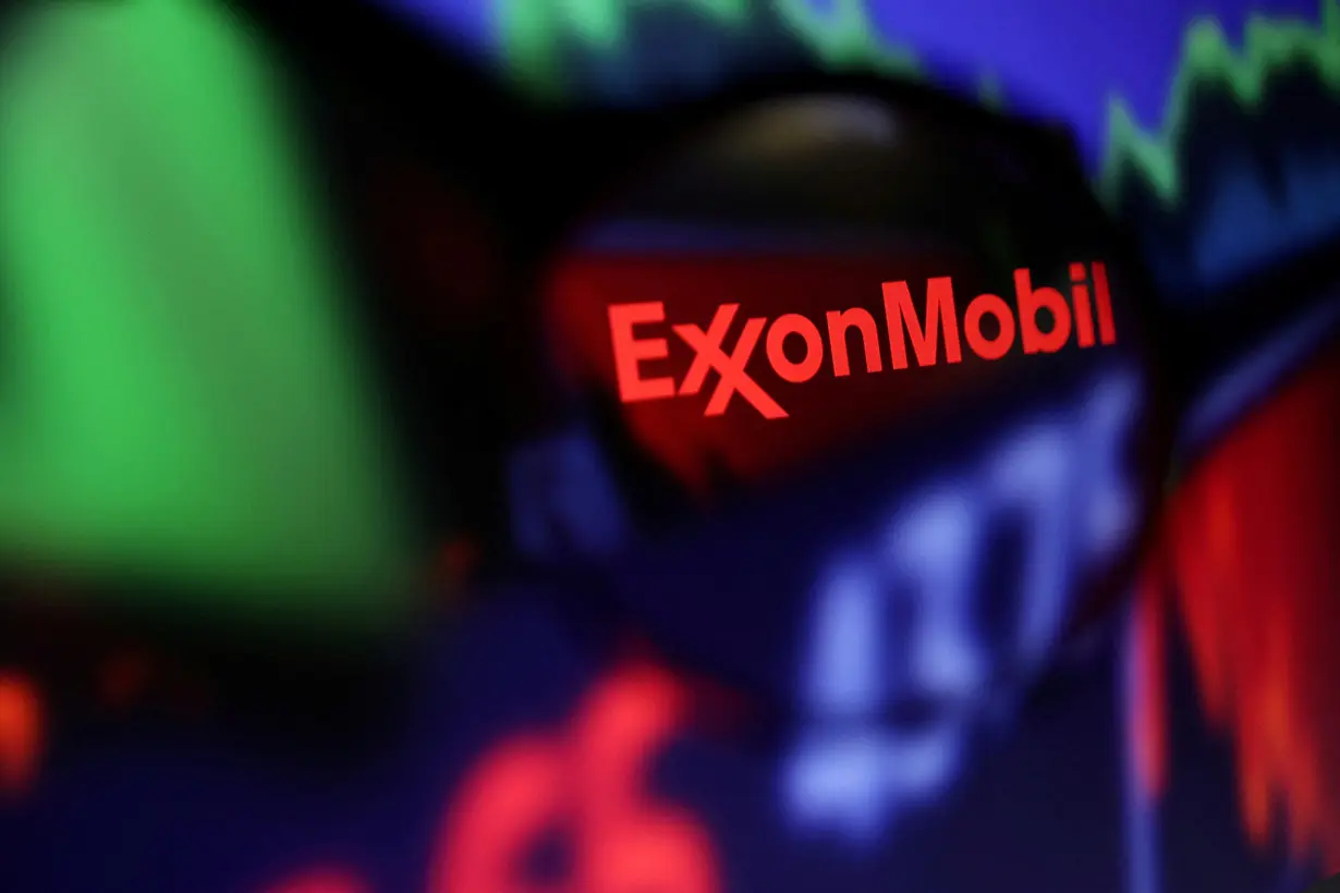 FILE PHOTO: FILE PHOTO: Illustration shows Exxon Mobil logo and stock graph