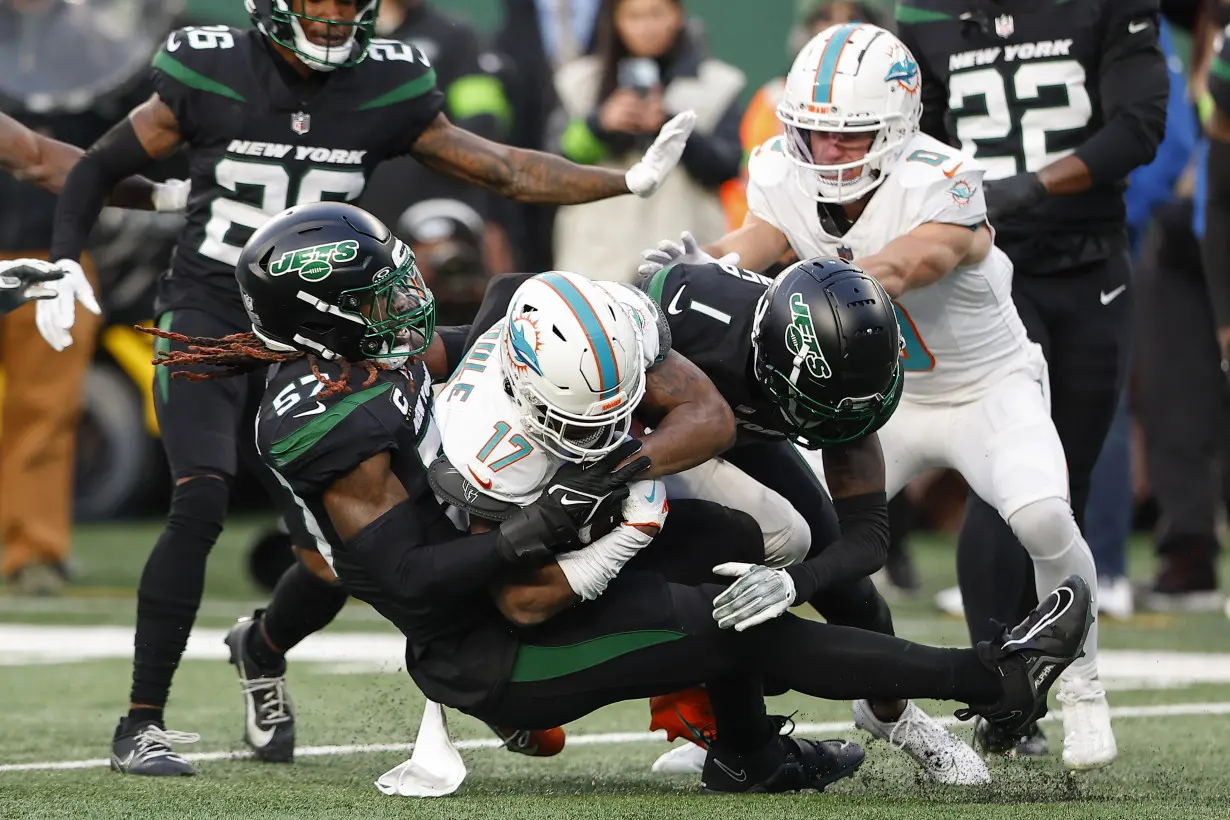 Hill's special TD catch and Holland's 99-yard INT return lead Dolphins past Jets 34-13