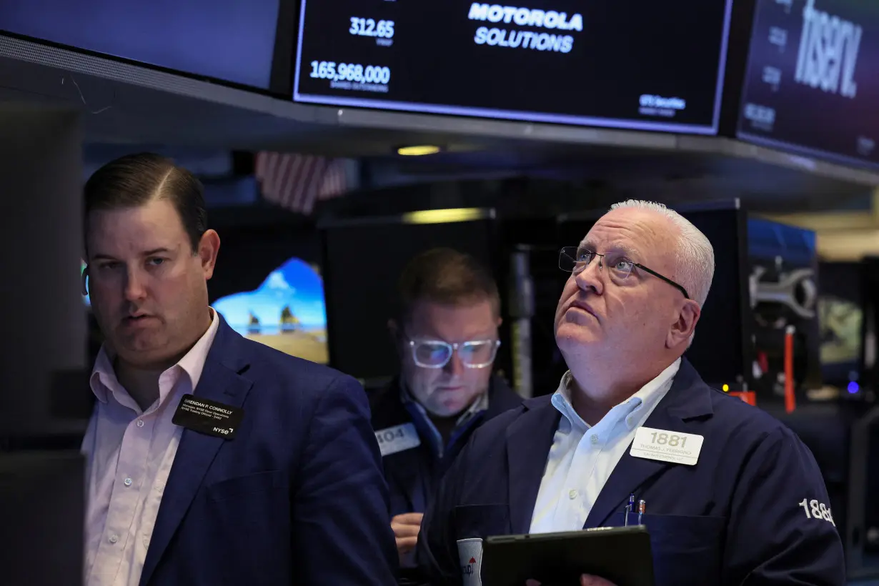 Traders work on the floor of the NYSE in New York