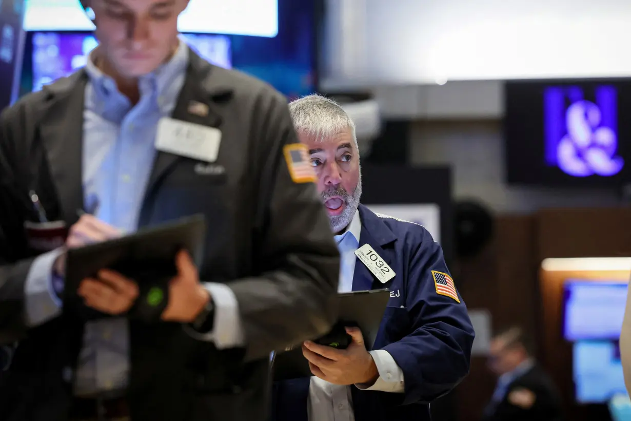 Traders work on the floor of the NYSE in New York