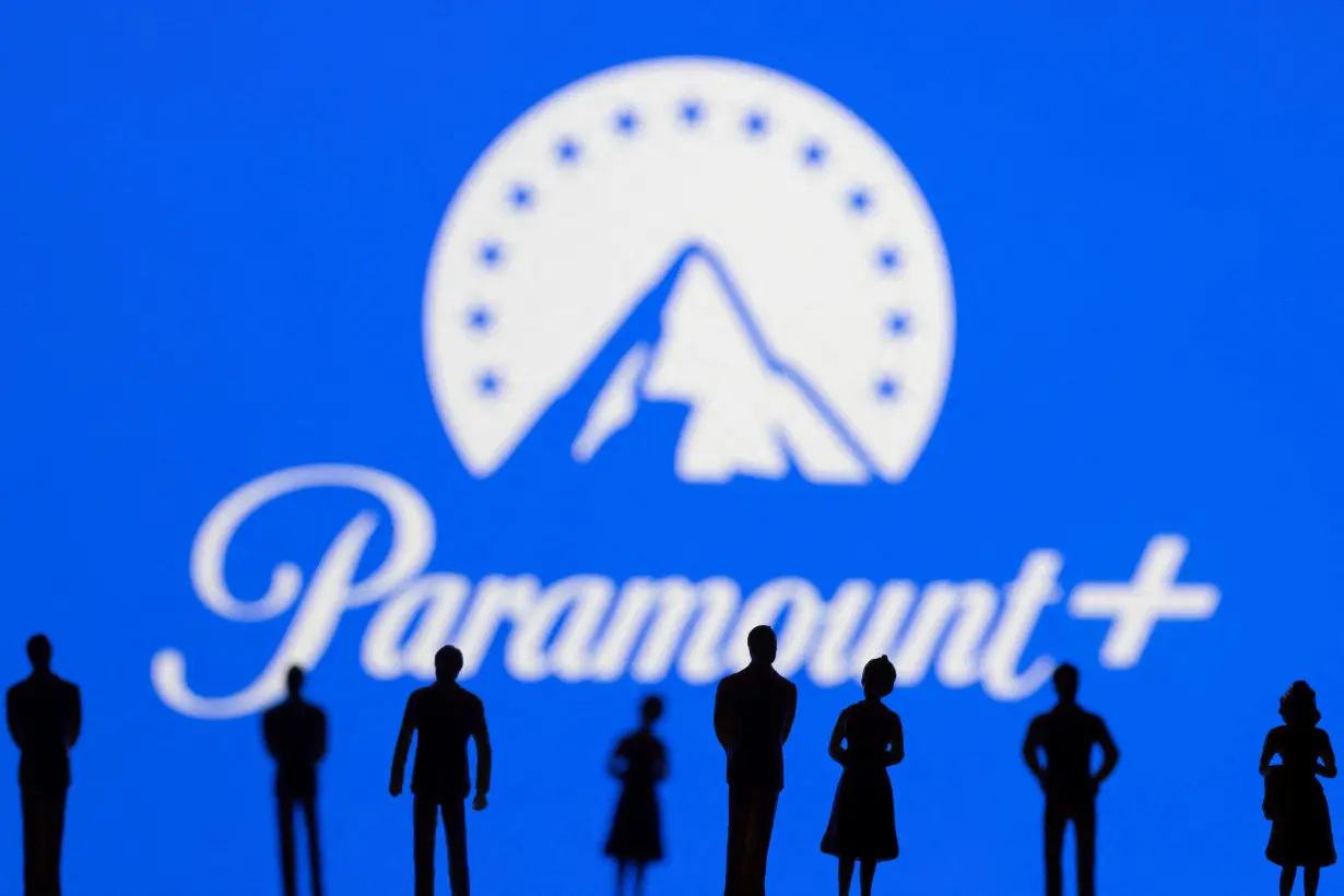 FILE PHOTO: Toy figures of people are seen in front of the displayed Paramount logo