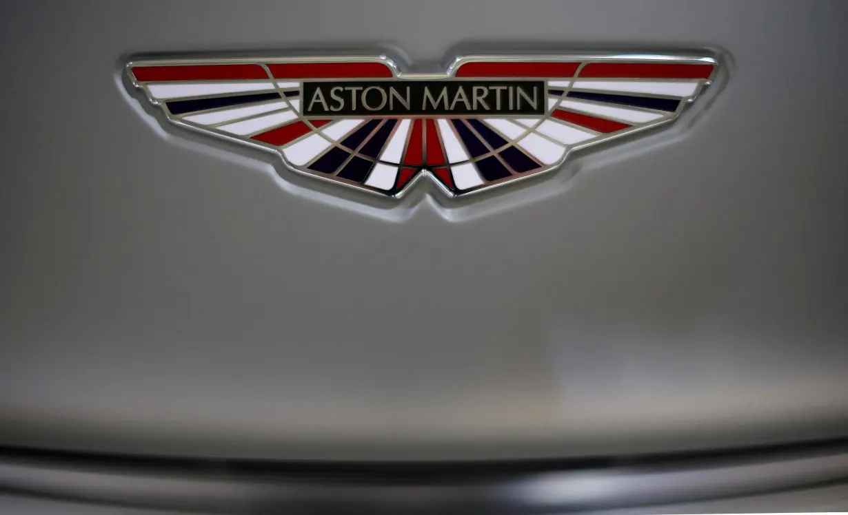 FILE PHOTO: The Aston Martin logo is seen on a V12 Vantage car at the company’s factory in Gaydon