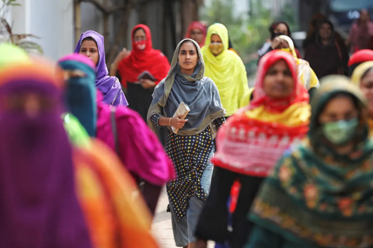 Garment workers come out of a factory during lunch hours at the Ashulia area, outskirts of Dhaka