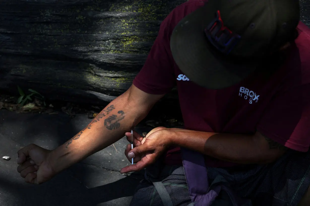 FILE PHOTO: A drug consumer injects a mixture of the opioid fentanyl and heroin at Richman (Echo) Park in the Bronx borough of New York City