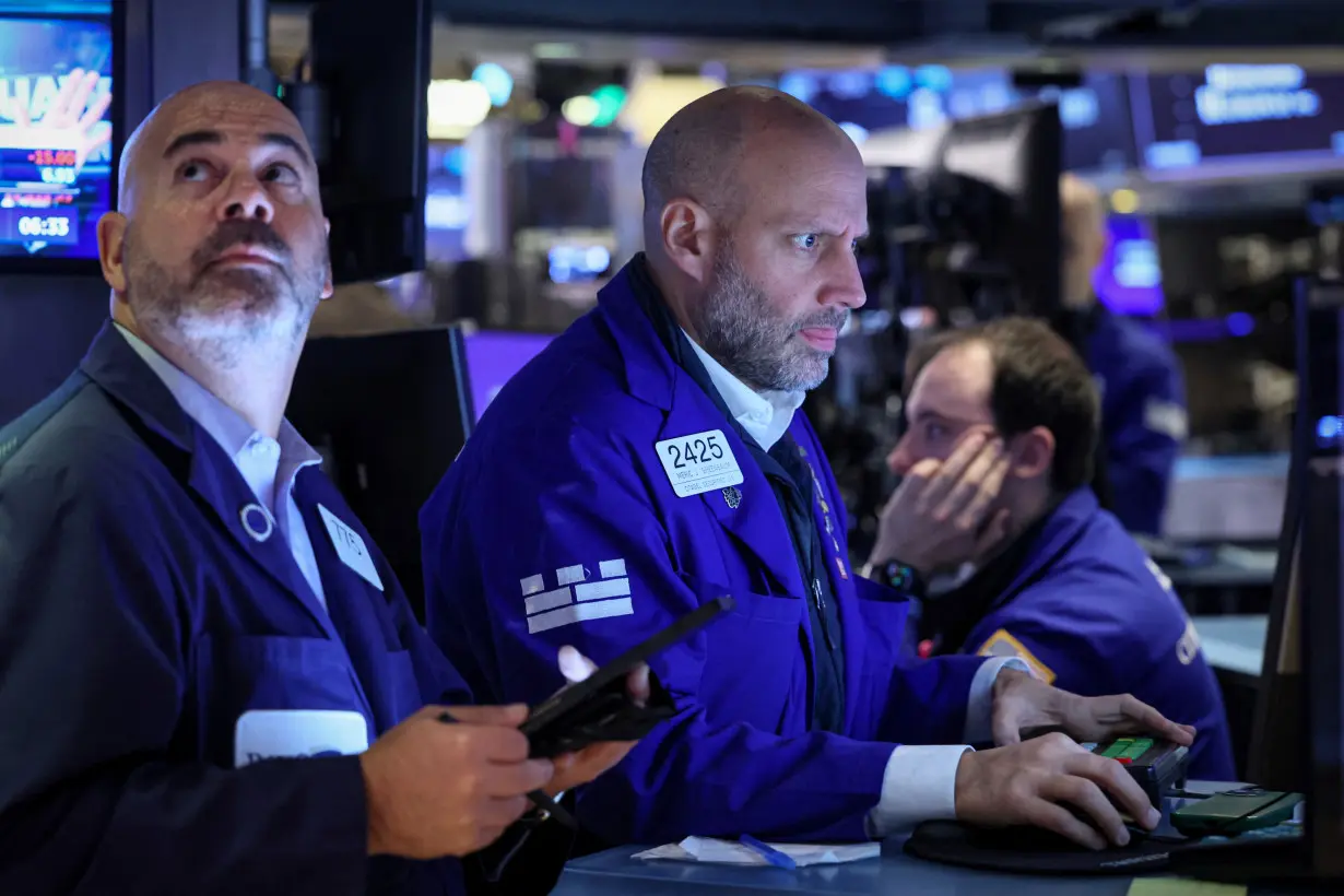 Traders work on the floor of the NYSE in New York