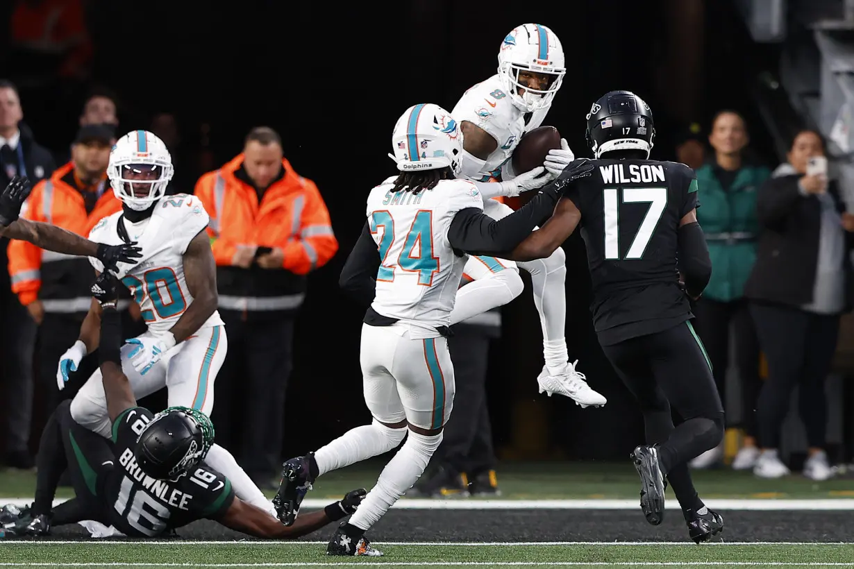 Hill's special TD catch and Holland's 99-yard INT return lead Dolphins past Jets 34-13