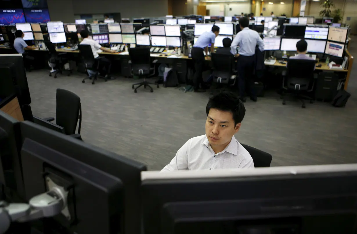 A currency dealer works at a dealing room of a bank in Seoul