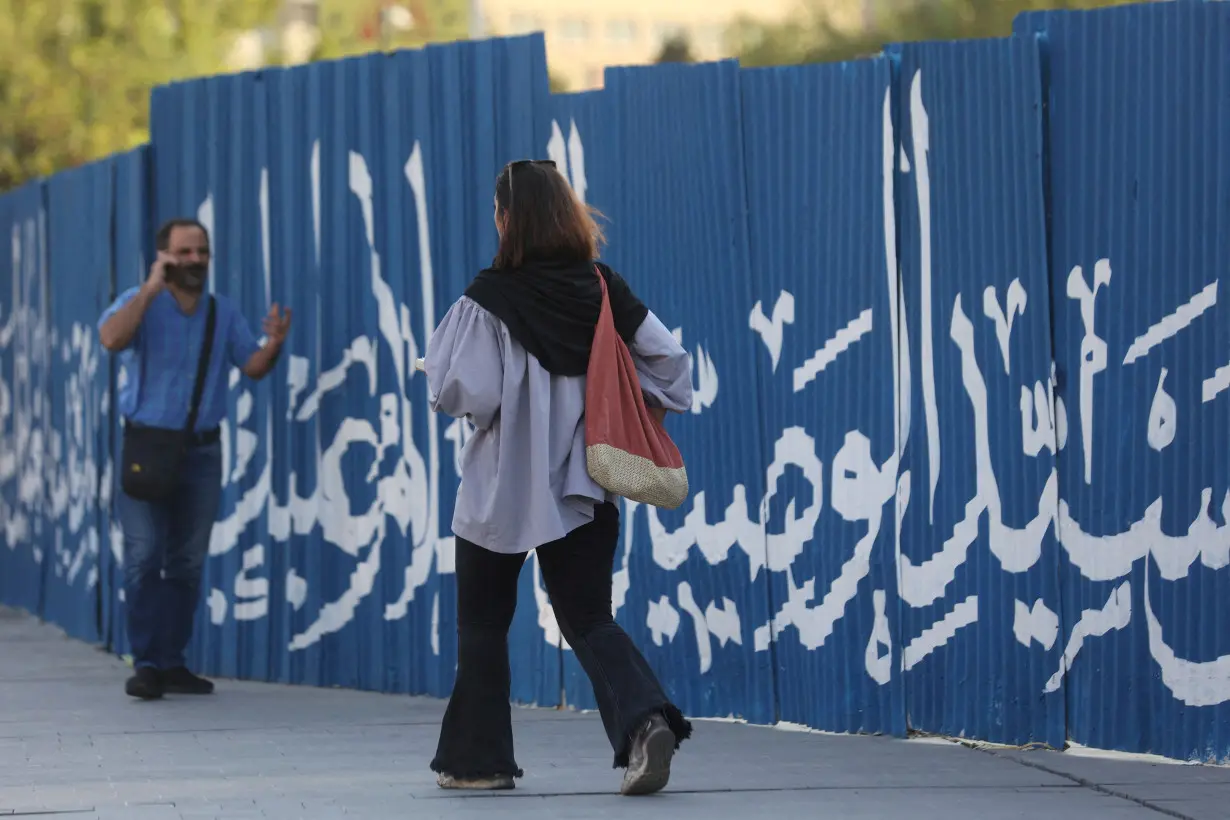 FILE PHOTO: An Iranian woman walks on a street in Tehran