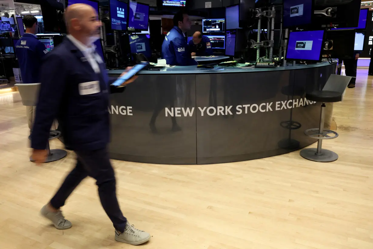 Traders work on the floor of the NYSE in New York