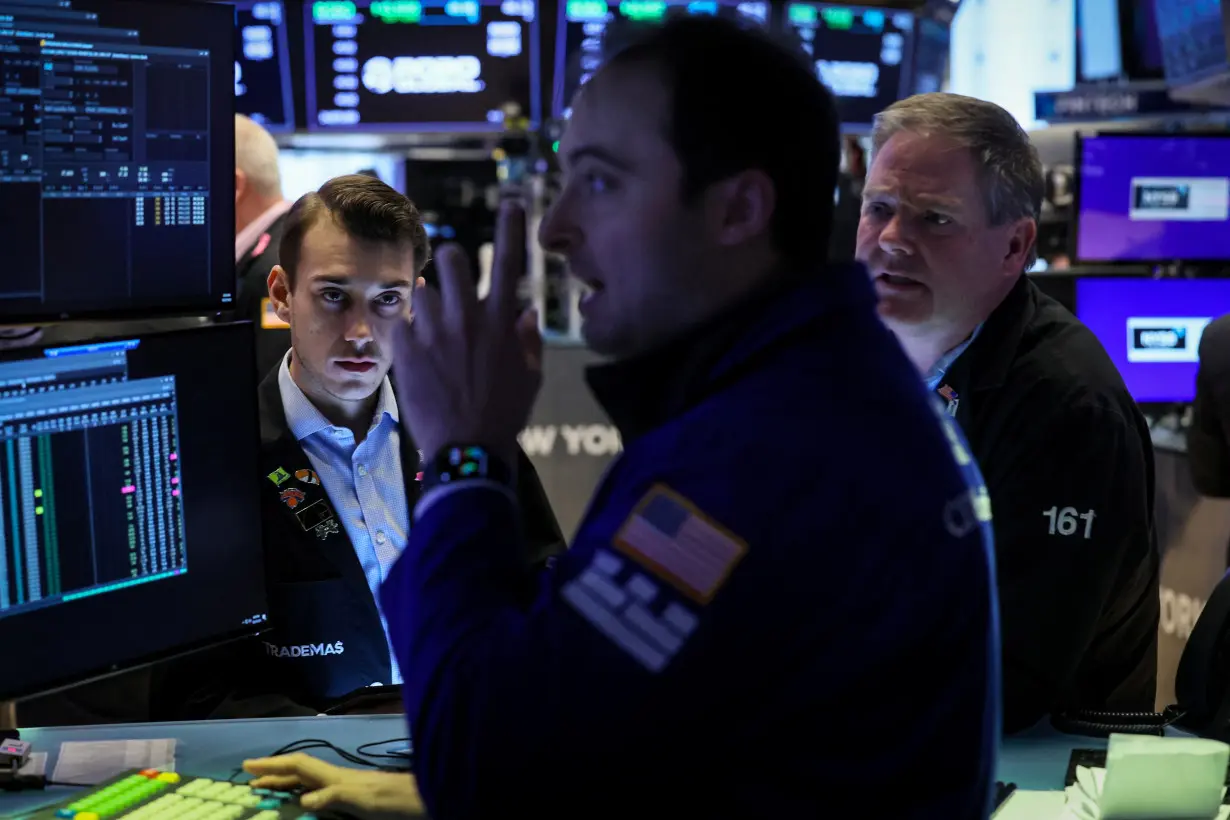 Traders work on the floor of the NYSE in New York