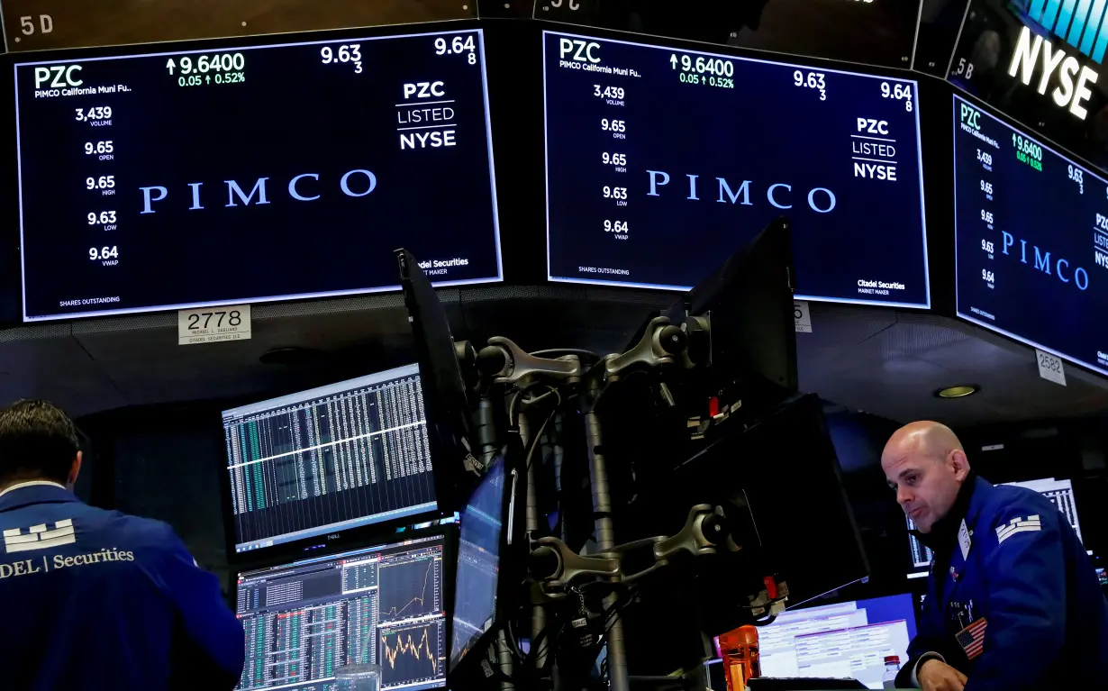 Ticker and trading information for PIMCO are displayed on a screen at NYSE in New York