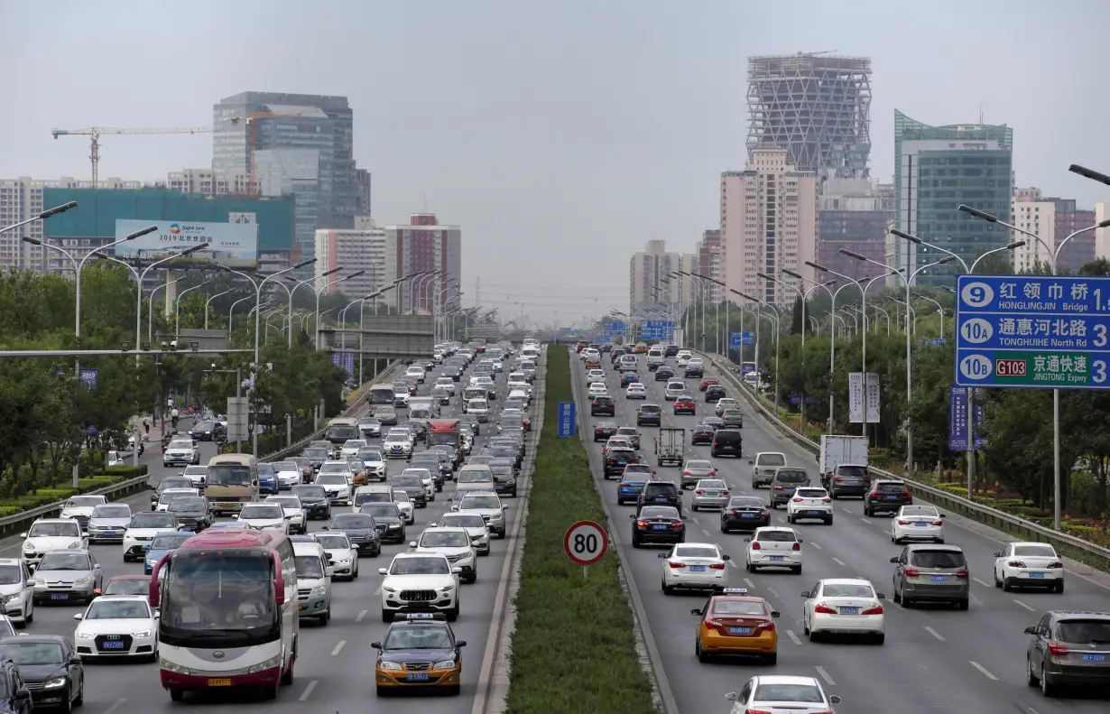 FILE PHOTO: Cars drive on the road during the morning rush hour in Beijing