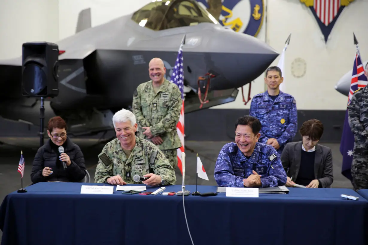 United States Seventh Fleet Vice Admiral and Japan Maritime Self-Defence Force Vice Admiral react during a press conference aboard USS Carl Vinson, in the Pacific Ocean