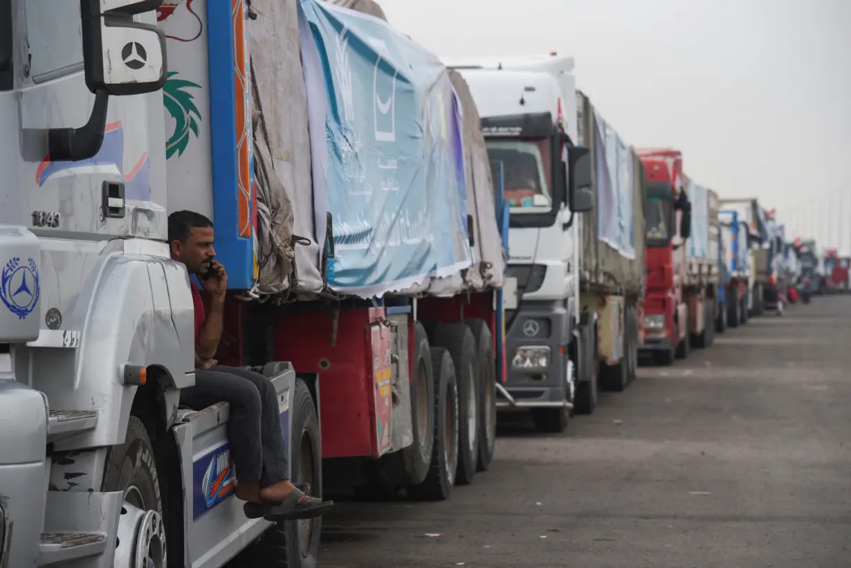 Trucks carrying humanitarian aid to Palestinians, wait on the desert road (Cairo - Ismailia) on their way to the Rafah border crossing to enter Gaza