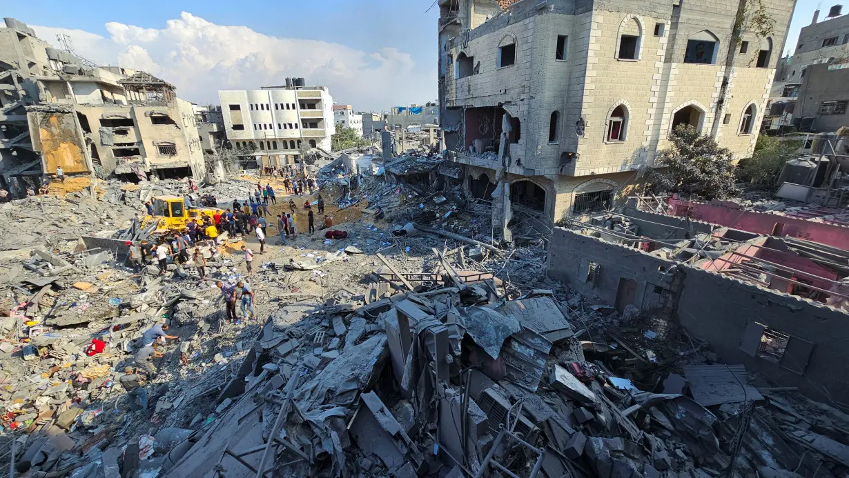Palestinians gather at the site of Israeli strikes on houses in Jabalia refugee camp