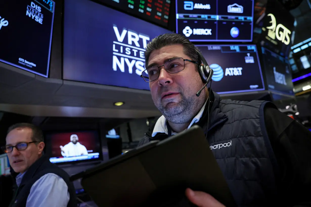 FILE PHOTO: Traders work on the floor of the NYSE in New York