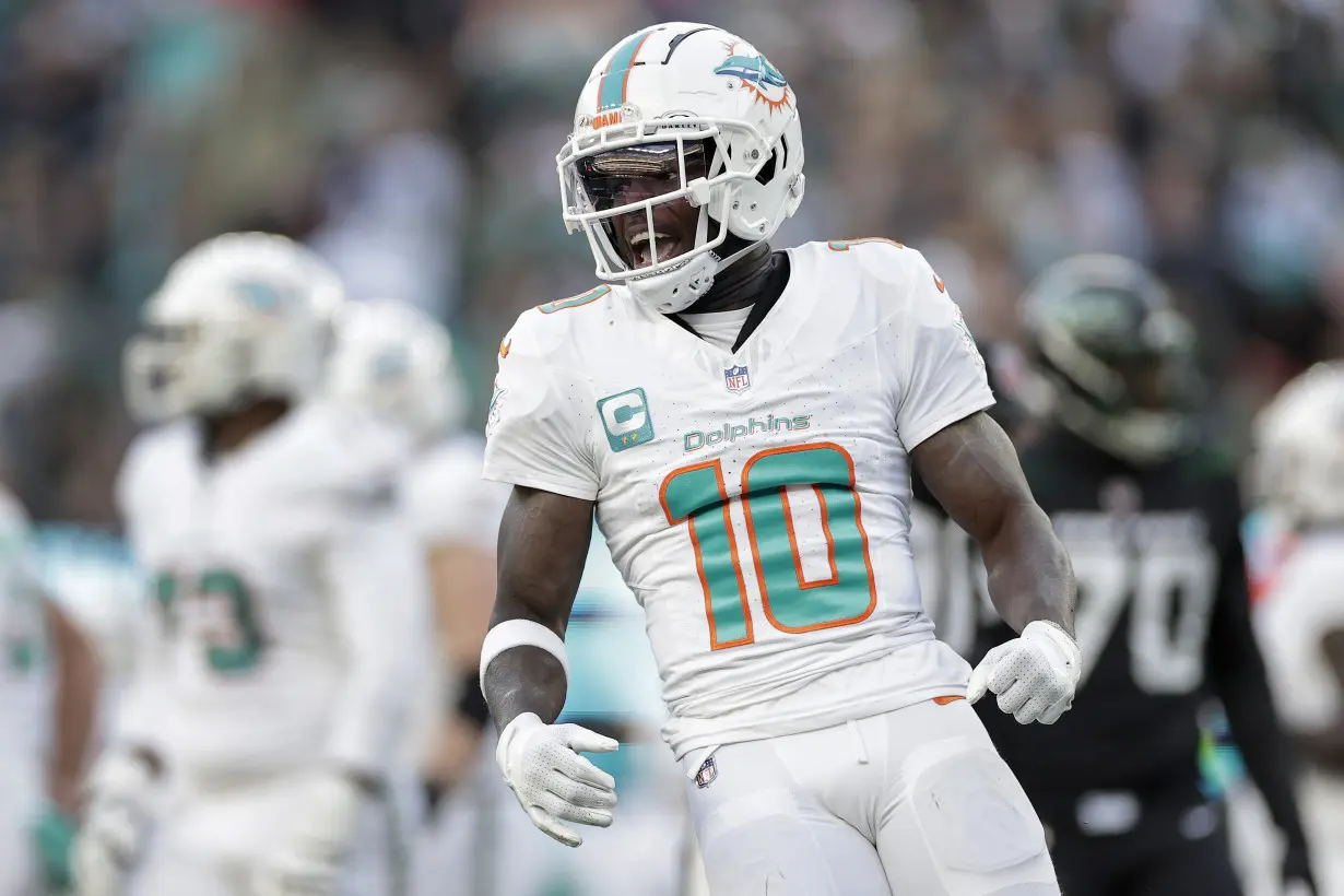 Hill's special TD catch and Holland's 99-yard INT return lead Dolphins past Jets 34-13